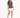 A woman stands confidently in a gray t-shirt paired with a white mini skirt and black high-heeled sandals.