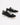 Black canvas sneakers with white laces and rubber soles, featuring a casual design and contrasting stitching.