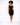 A model with curly hair wears a fitted black dress paired with white sneakers, standing against a light background.