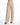 Beige wide-leg pants with pleats, featuring a button closure and side pockets, styled with black heeled sandals.