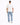 A person wearing a white t-shirt and light blue jeans stands with their back to the camera.