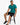 Carbon Classic Tee in turquoise, seated on a stool