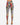 Colorful patterned leggings featuring abstract designs and script, paired with stylish black heels.