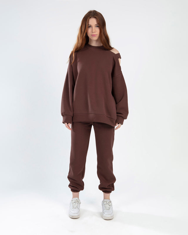 Model wearing Jolene burgundy two-piece set featuring cold-shoulder sweatshirt and matching joggers.