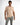 Model in peach Ryan Polo Shirt, a short sleeve polo for men paired with grey casual trousers.