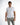 Model in the Ryan white polo shirt with grey trousers, highlighting a clean casual aesthetic for men's streetwear.