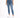 A person wearing a white cropped top and blue high-waisted skinny jeans, paired with white sneakers.