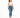 A woman stands in a fitted white crop top and blue skinny jeans, paired with white sneakers.