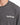 Gray t-shirt featuring a white, stylized text graphic that reads "challenge" on the chest area.