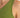 Close-up of a green sleeveless top, showcasing the smooth fabric around the shoulder area.