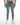 Men's Carbon Kase jeans in light blue washed denim with heavy knee distressing, styled with white sneakers.