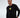 Model in Keep On Moving black long-sleeve graphic streetwear shirt with yellow urban design and Carbon logo.