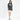 Model in Sanatond Campus grey washed oversized hoodie with a graphic print, white mini skirt, and tan heels.