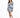 A woman poses in a fitted dress with puffed sleeves and a blue tropical print, paired with white sneakers.