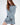 Model wearing the Saylor Blue Oversized Sweater, featuring a light blue distressed cable knit design.