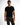 A man stands confidently in a fitted black t-shirt and olive green cargo pants, showcasing a casual style.