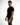 A man stands sideways wearing a fitted black t-shirt and olive green cargo pants, showcasing a casual style.