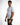 A man stands confidently in a fitted white t-shirt paired with olive green cargo pants and bracelets.
