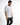 A young man wearing a fitted white t-shirt with colorful text and a graphic design, paired with dark jeans.