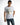 A man wearing a white t-shirt with a graphic print and text, paired with blue jeans.