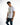 A model poses in a fitted white t-shirt featuring a transparent pocket with printed text, paired with blue jeans.