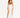 A model poses in a white skirt with high slits, paired with a brown crop top and black strappy heels.