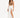 A model poses in a flowing white skirt with high slits, paired with a brown crop top and black heels.