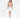 Model wearing Serena cable knit turtleneck sweater in tan with a white mini skirt and heels against a white background.
