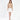 Model wearing Serena cable knit turtleneck sweater in tan with a white mini skirt and heels against a white background.