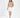 Serena beige cable knit turtleneck sweater paired with a white mini skirt.