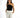 A model poses in a stylish black one-shoulder top paired with tailored white trousers.