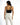 A woman stands with her back to the camera, wearing a black one-shoulder top and white fitted pants.
