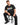 A man sits on a black stool wearing a dark t-shirt featuring colorful graphic designs and text.