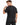A man with short hair wearing a dark gray t-shirt, looking back while adjusting the neckline.
