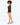 A model poses in a sheer long-sleeve top and high-waisted shorts, paired with strappy black heels.