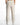 Rear view of Kinley white wide-leg utility pants featuring an elastic high waistband and relaxed streetwear fit on a model.