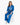 A model sits wearing vibrant blue pants and a matching hoodie with a graphic design, paired with white sneakers.