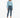 A model stands wearing a light blue long-sleeve top, high-waisted dark jeans, and white slide sandals.