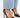 Black high-heeled shoes with a pointed toe, paired with light blue denim, showcasing a sleek and elegant design.