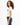 Side view of L.A. Vibes White Crop Top with red graphic on a model with curly hair, paired with dark blue jeans.