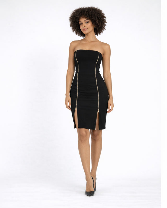A model poses in a strapless black dress featuring gold zipper details and thigh-high slits, paired with black heels.