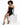 A model poses in a fitted black strapless dress with gold zipper details, paired with black high heels.
