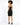 A model with curly hair poses in a fitted black strapless dress featuring a gold zipper detail at the back.