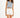Woman in a blue-grey L.A. streetwear graphic tank top with raw hem and white high-waisted denim shorts.