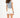 Back view of woman in Blue Grey L.A. Essential Tank Top with raw hem and white high-waisted streetwear shorts.