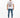 A man stands wearing a white graphic t-shirt featuring a lion design, paired with distressed blue jeans and white sne...