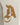 Beige apparel featuring a textured, brown logo design on the thigh, adding a unique visual element.