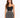 A model poses in a fitted black top and a flared skirt featuring a monochrome animal print design.