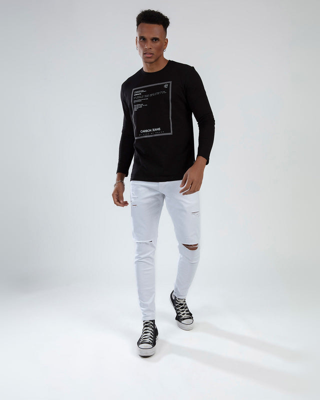 Model wearing a black long-sleeve graphic tee, ripped white skinny jeans, and black high-top sneakers.