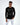 Man in a black long-sleeve streetwear shirt with a graphic box print and white distressed jeans.